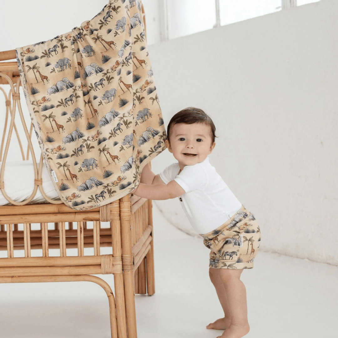 Baby-Standing-Holding-Cot-Wearing-Aster-and-Oak-Organic-Cotton-Safari-Pocket-Shorts-Naked-Baby-Eco-Boutique