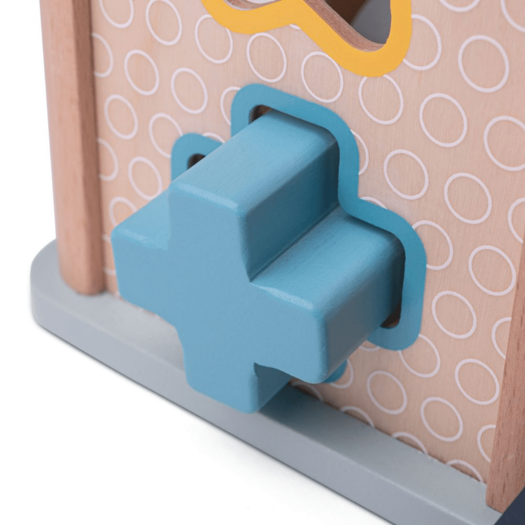 Bigjigs-Shape-Sorter-Close-Up-Of-Cross-Shape-Fitting-Into-Hole-Naked-Baby-Eco-Boutique