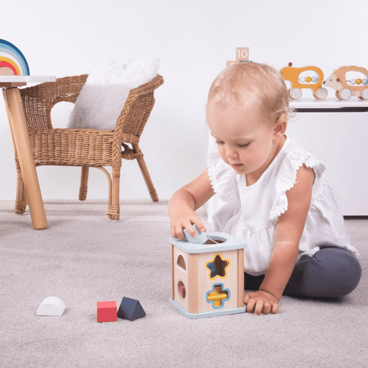 Bigjigs-Shape-Sorter-Little-Girl-Putting-Shape-Into-Shape-Sorter-Naked-Baby-Eco-Boutique