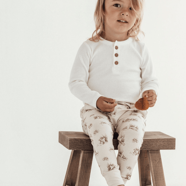 Child-Sitting-on-Stool-Wearing-Aster-and-Oak-Organic-Cotton-Harem-Pants-Beaver-Naked-Baby-Eco-Boutique