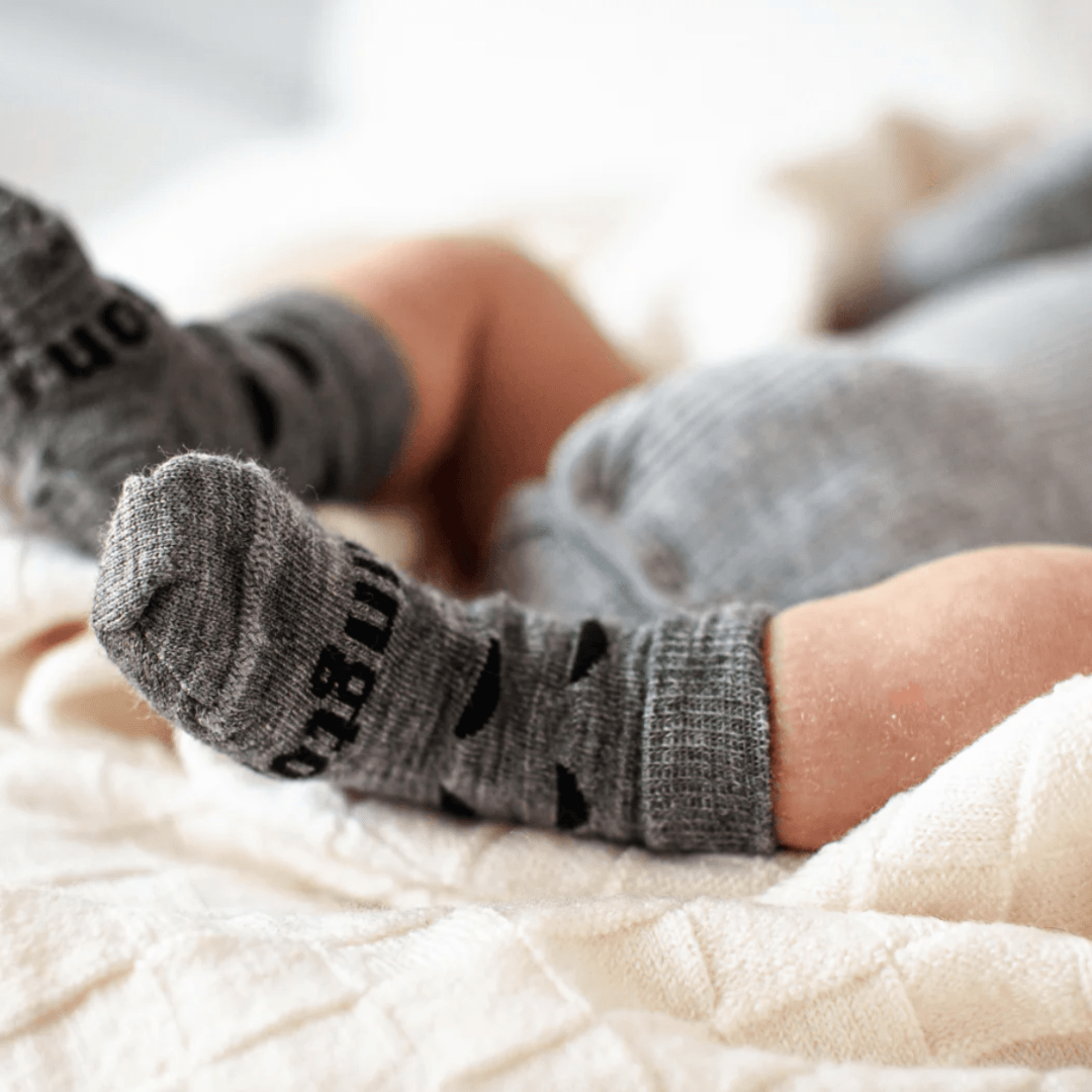 Close-up-of-Tiny-Baby-Feet-Wearing-Lamington-Merino-Wool-Crew-Baby-Socks-Thor-Naked-Baby-Eco-Boutique