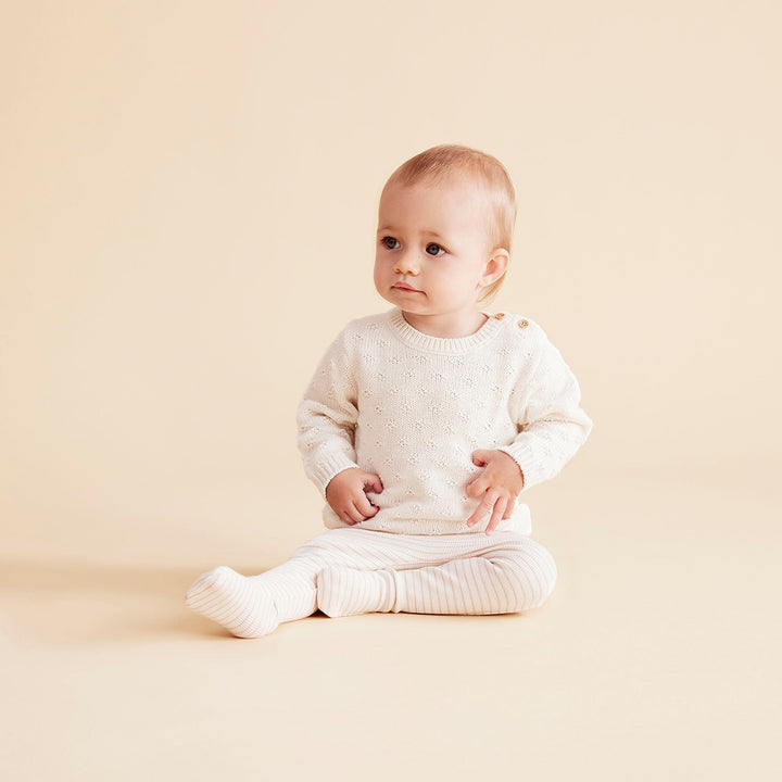 Cute-Baby-Girl-Sitting-Wearing-Wilson-and-Frenchy-Organic-Rib-Stripe-Footed-Leggings-Cameo-Rose-Naked-Baby-Eco-Boutique