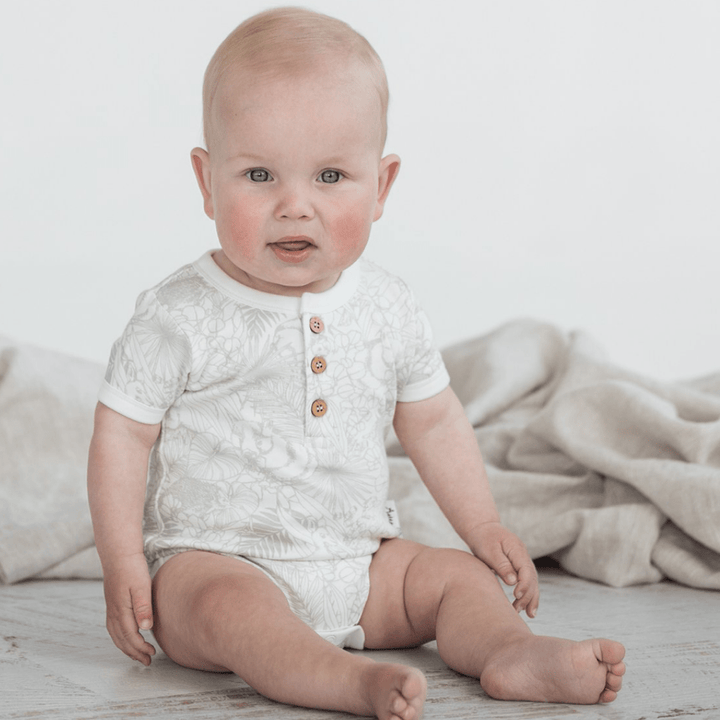 Cute-Baby-with-Blanket-Wearing-Aster-and-Oak-Organic-Animal-Henley-Onesie-Naked-Baby-Eco-Boutique