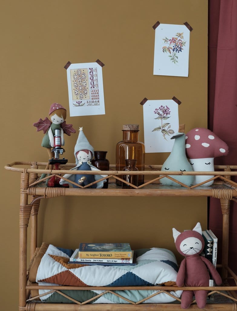 A wicker shelf with a Fabelab Organic Cotton Pear Cushion - LUCKY LASTS on it.