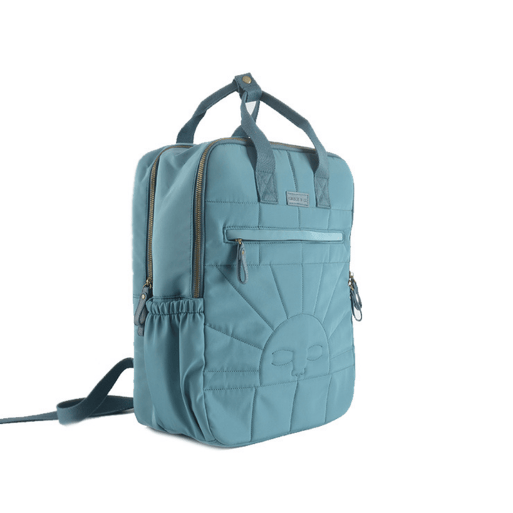 The Grech & Co. Large Backpack in Laguna is a light blue kids' backpack featuring padded shoulder straps, top handles, a front pocket with a sunburst design, and an additional side pocket. The brand label is affixed above the front pocket. Despite being slightly damaged, this eco-friendly backpack from Grech & Co. is perfect for everyday adventures.