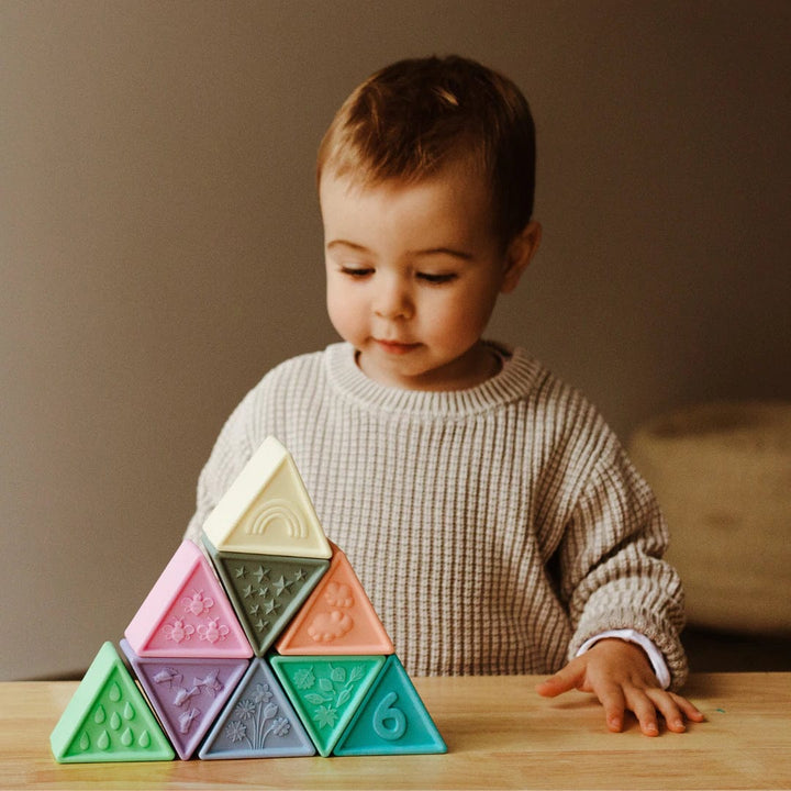 Jellystone-Designs-Silicone-Triblox-Little-Boy-Playing-With-Pastel-Blocks-Naked-Baby-Eco-Boutique