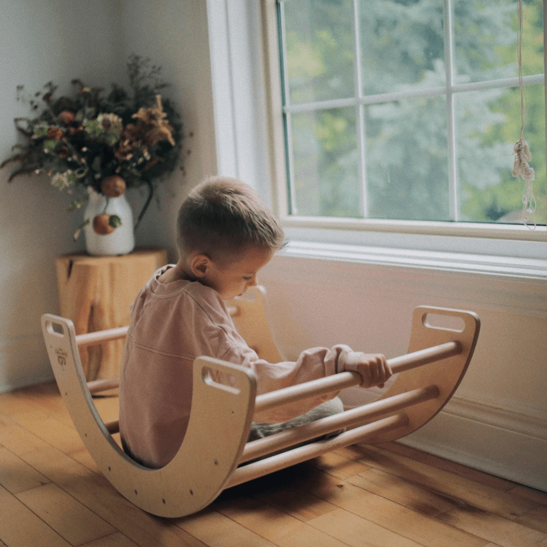 Little-Boy-Rocking-in-Kinderfeets-Pikler-Rocking-and-Climbing-Arch-Naked-Baby-Eco-Boutique