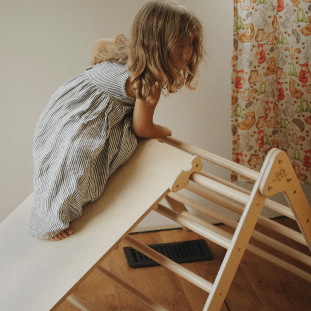 Little-Girl-Playing-on-Slide-with-Kinderfeets-Pikler-Triangle-Medium-Naked-Baby-Eco-Boutique