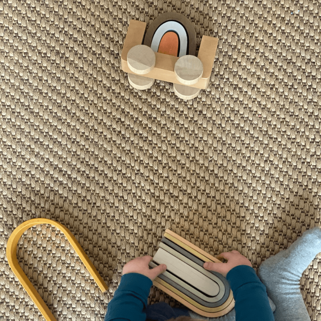 Little-Girl-on-Floor-Playing-with-MinMin-Copenhagen-Large-Wooden-Rainbow-Pastel-Naked-Baby-Eco-Boutique