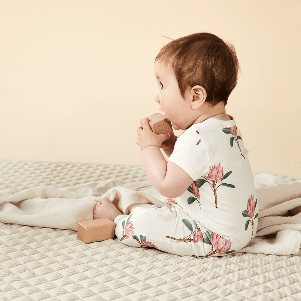 Side-View-of-Cute-Baby-Wearing-Wilson-and-Frenchy-Organic-Zipsuit-Pretty-Protea-Naked-Baby-Eco-Boutique